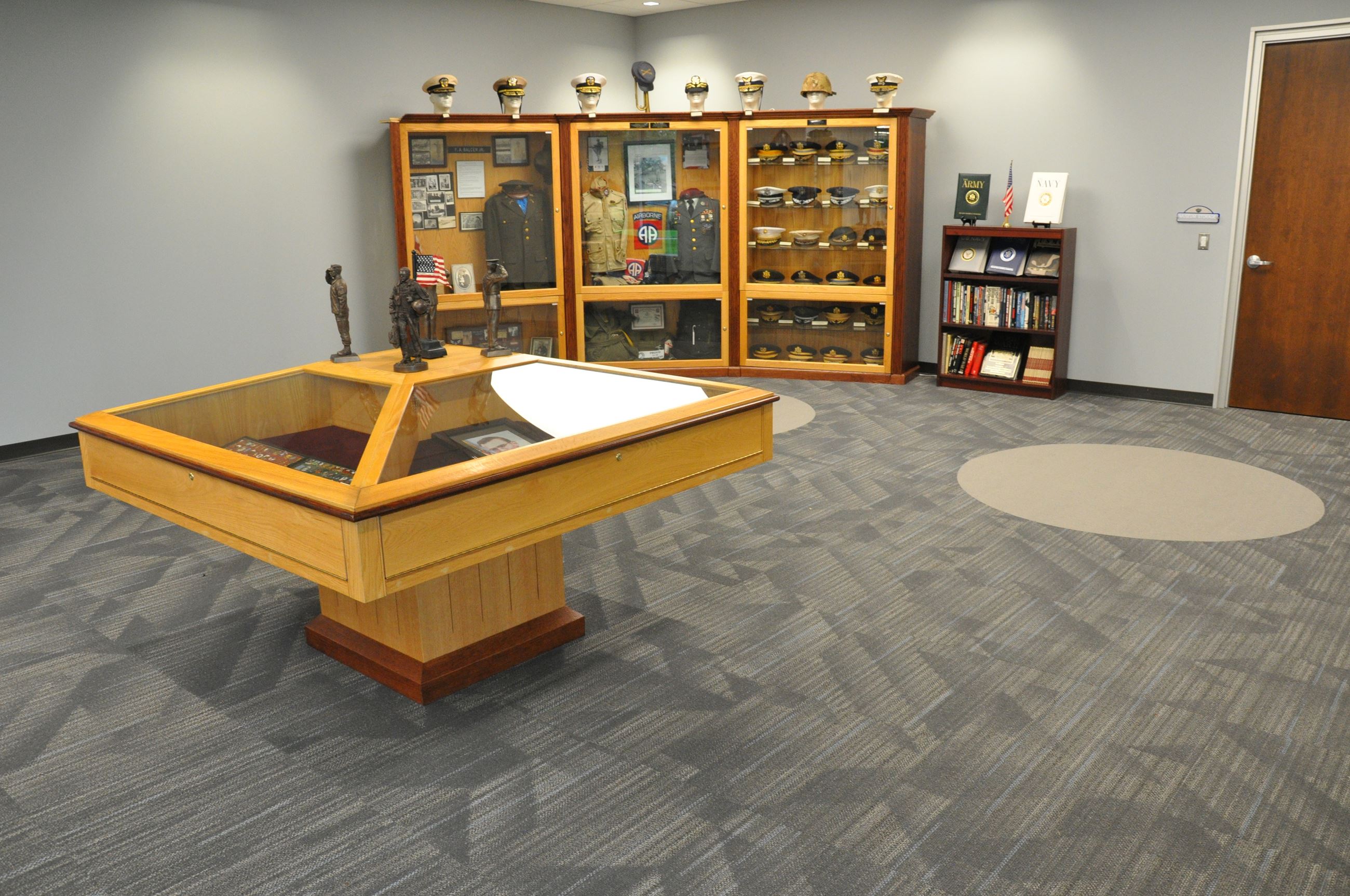 Displays of retired USA military uniforms and hats.