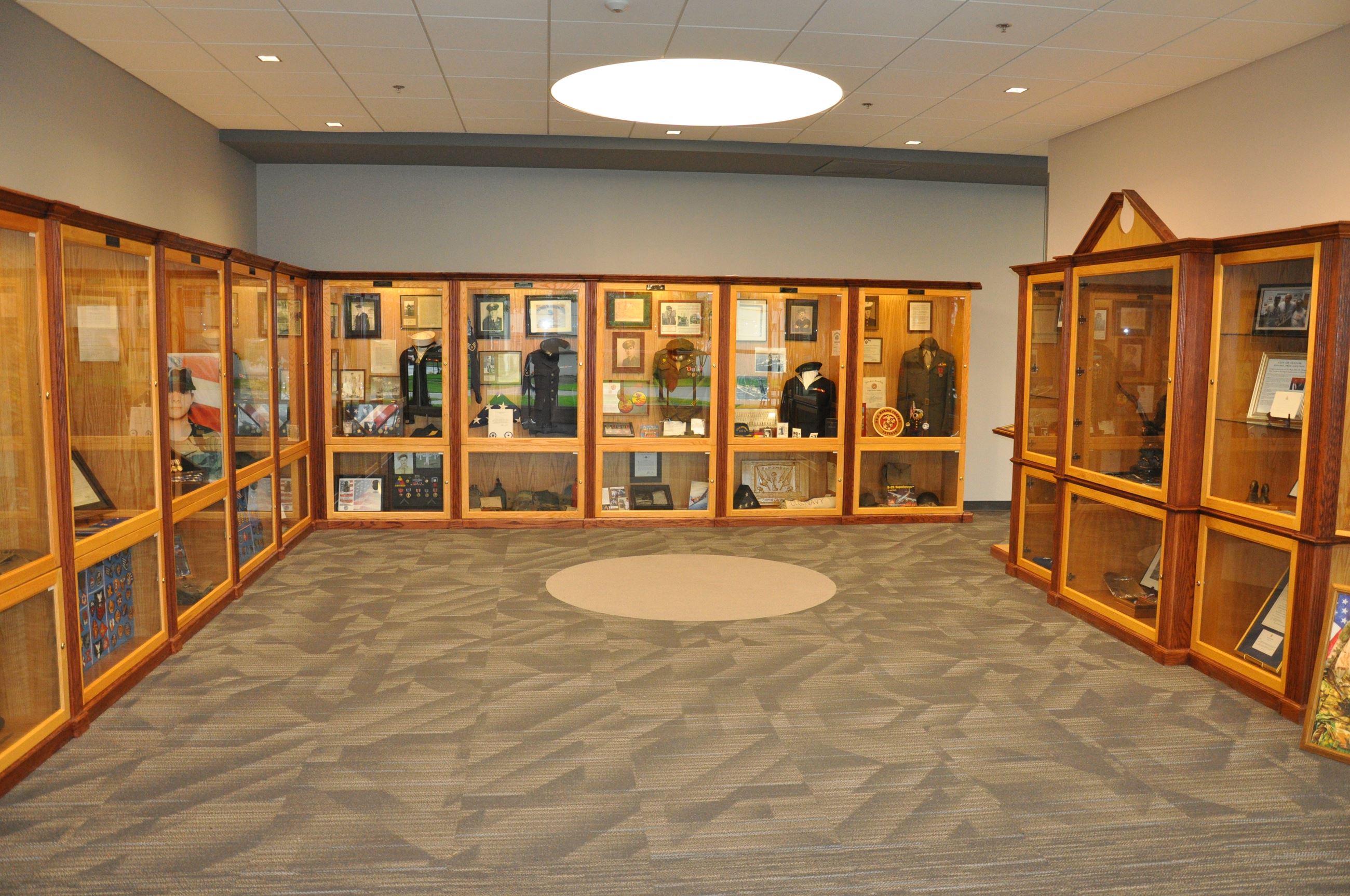 11 displays of retired miliary uniforms from various branches.