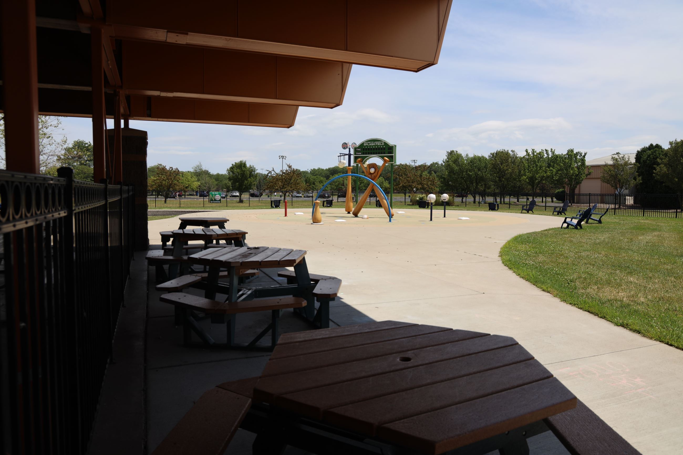 Baseball Themed Lamarand Splash Pad with picnic table seating area.