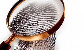 Stock image of a magnifing glass over a fingerprint. 