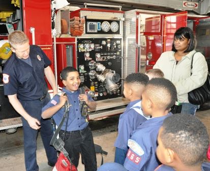 Fire fighter talking to a Cub Scout Troop about fire safety. 