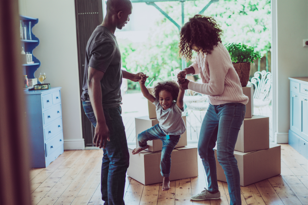 Family unpacking boxes in their house