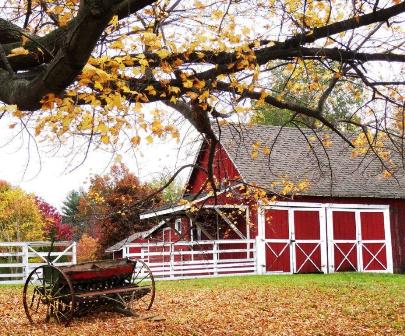 An old red and white barn alongside Heritage Park in Autumn. This barn no longer stands. 