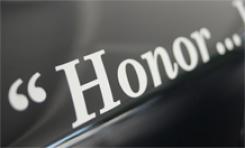 Vehicle sticker that reads, "Honor." 