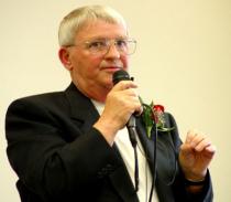 Bryan Cragg speaking into a microphone.