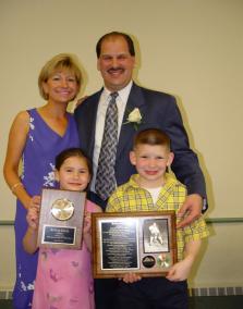 Jeffrey Dobek standing with his wife and two children.