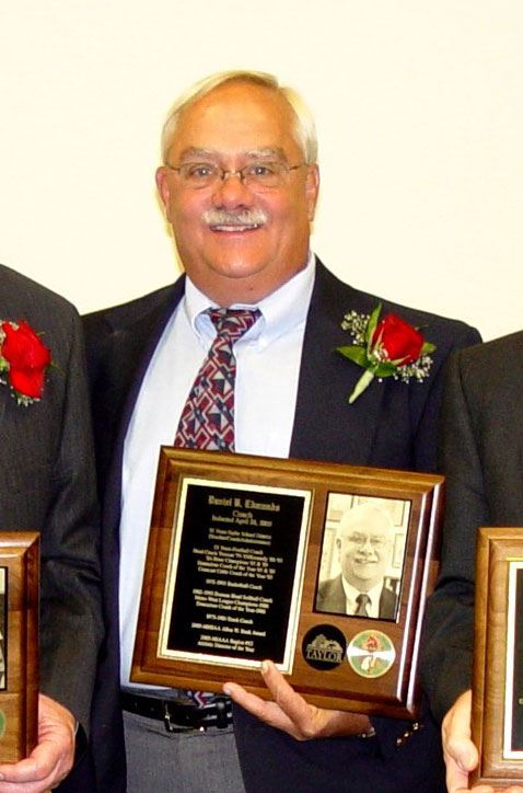 Daniel Edmunds holding a plaque.