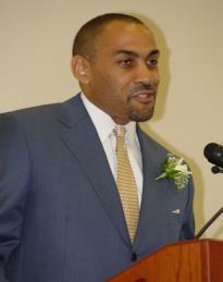 Shelby Johnson speaking at a podium.