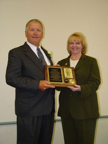 William Stephens and a woman holding a plaque.